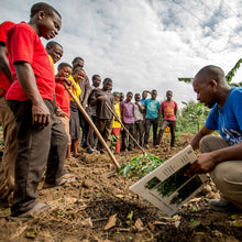 Load image into Gallery viewer, A group of people learning about agriculture for coffee